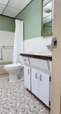 a bathroom with a sink toilet and mirror