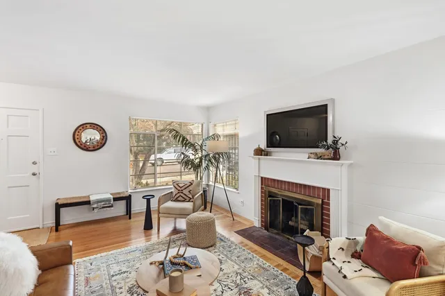 a living room with furniture a fireplace and a flat screen tv