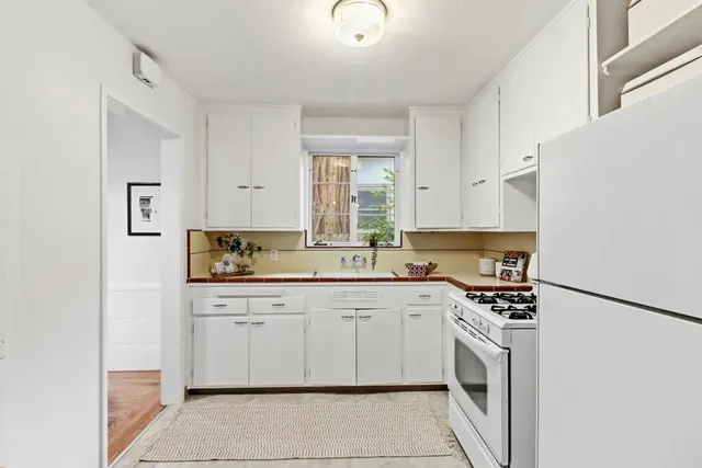 a kitchen with a sink cabinets and window