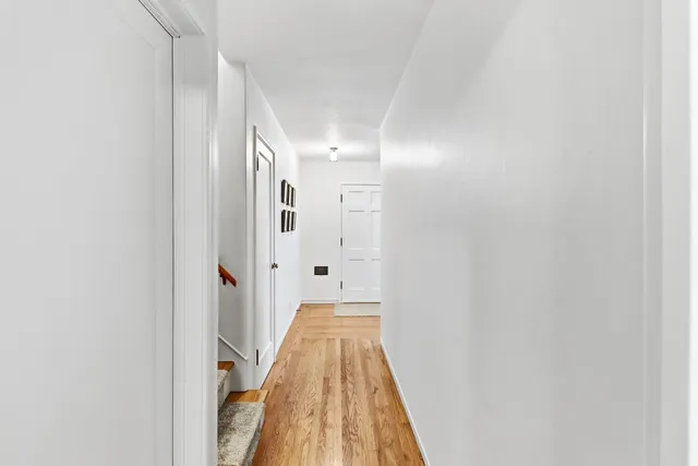 a view of a bathroom with sink and wooden floor