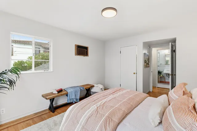 a bedroom with bed and a window