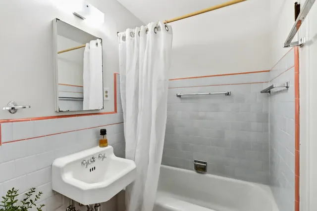 a bathroom with a sink a mirror and shower