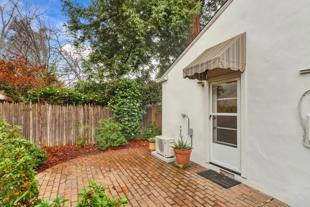 a view of a house with backyard and sitting area