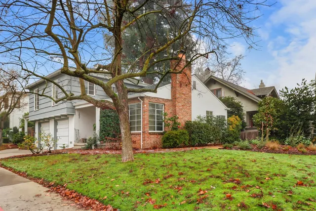 a white kitchen with a stove a sink and a refrigerator