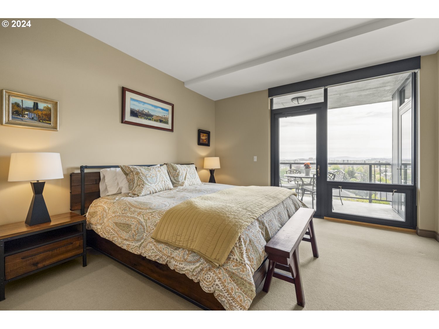 2454 Northwest Westover Road, Unit 405 Portland, OR 97210 - Photo 22 of 37 a bedroom with a bed and a large window