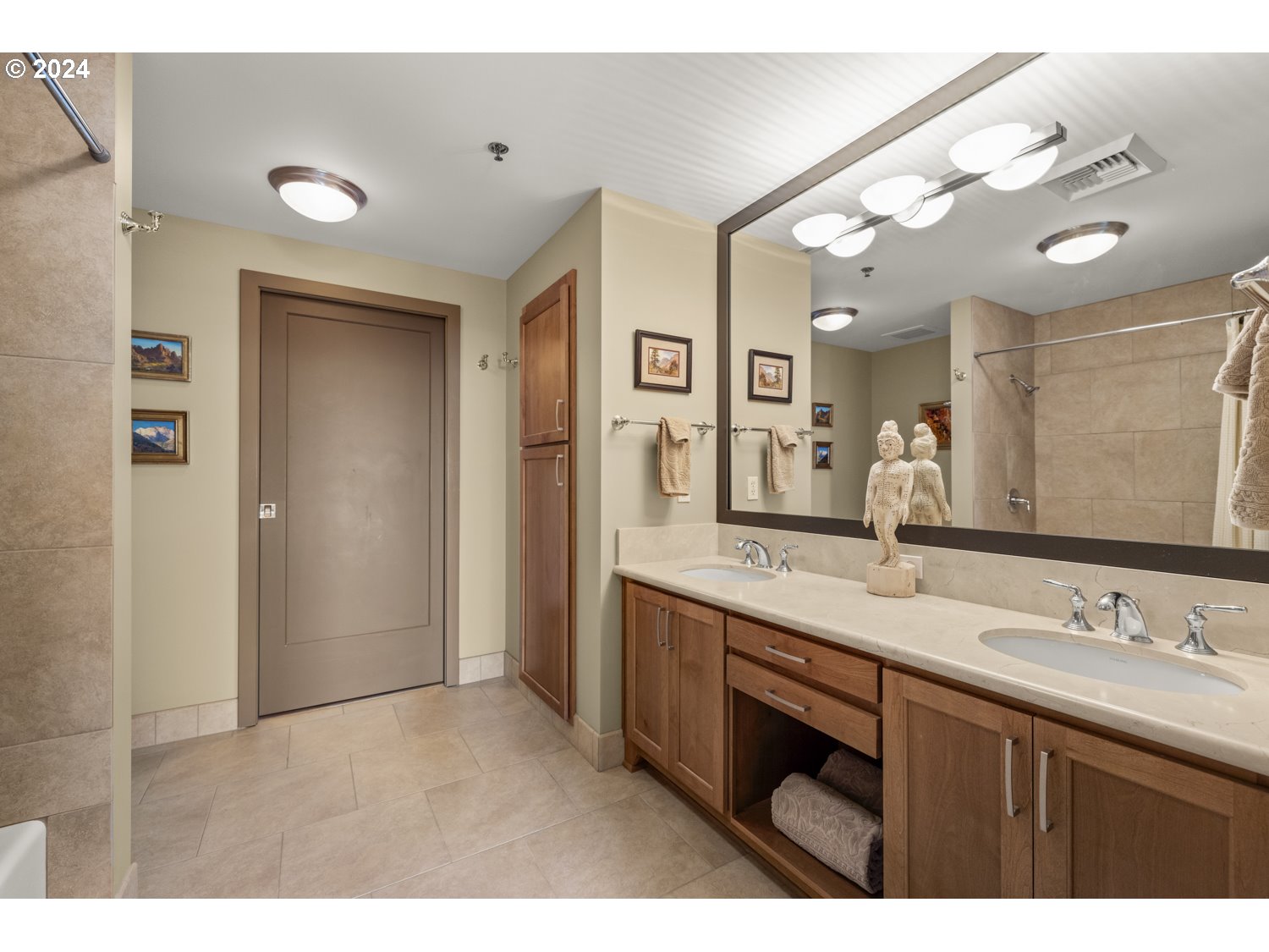 2454 Northwest Westover Road, Unit 405 Portland, OR 97210 - Photo 26 of 37 a bathroom with a granite countertop sink a large mirror and a shower