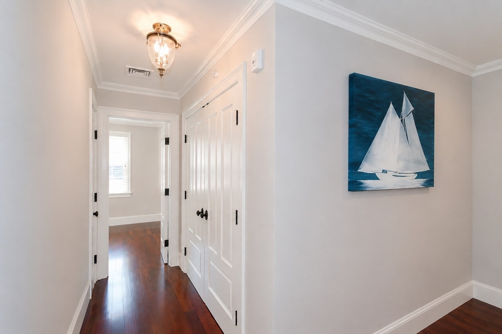 29 Maple Lane, Unit 29 Medfield, MA 02052 - Photo 27 of 42 a view of a hallway with wooden floor and closet