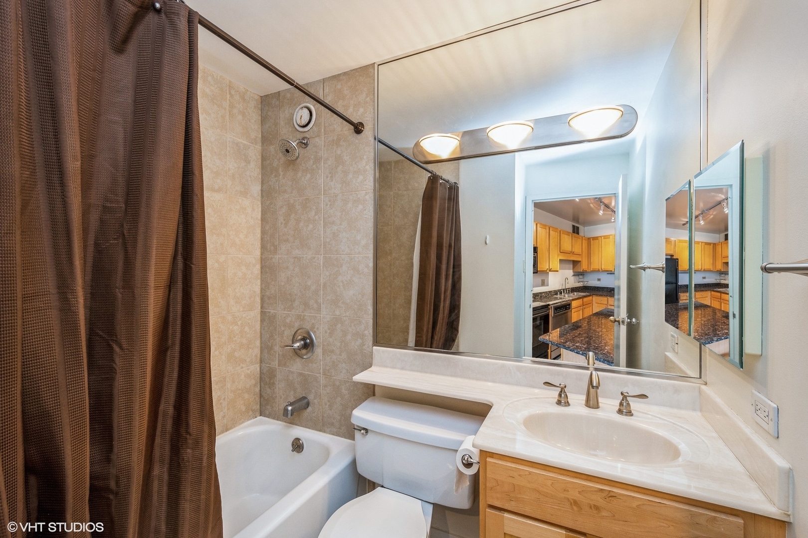 211 East Ohio Street, Unit 2011 Chicago, IL 60611 - Photo 8 of 19 a bathroom with a sink toilet and shower