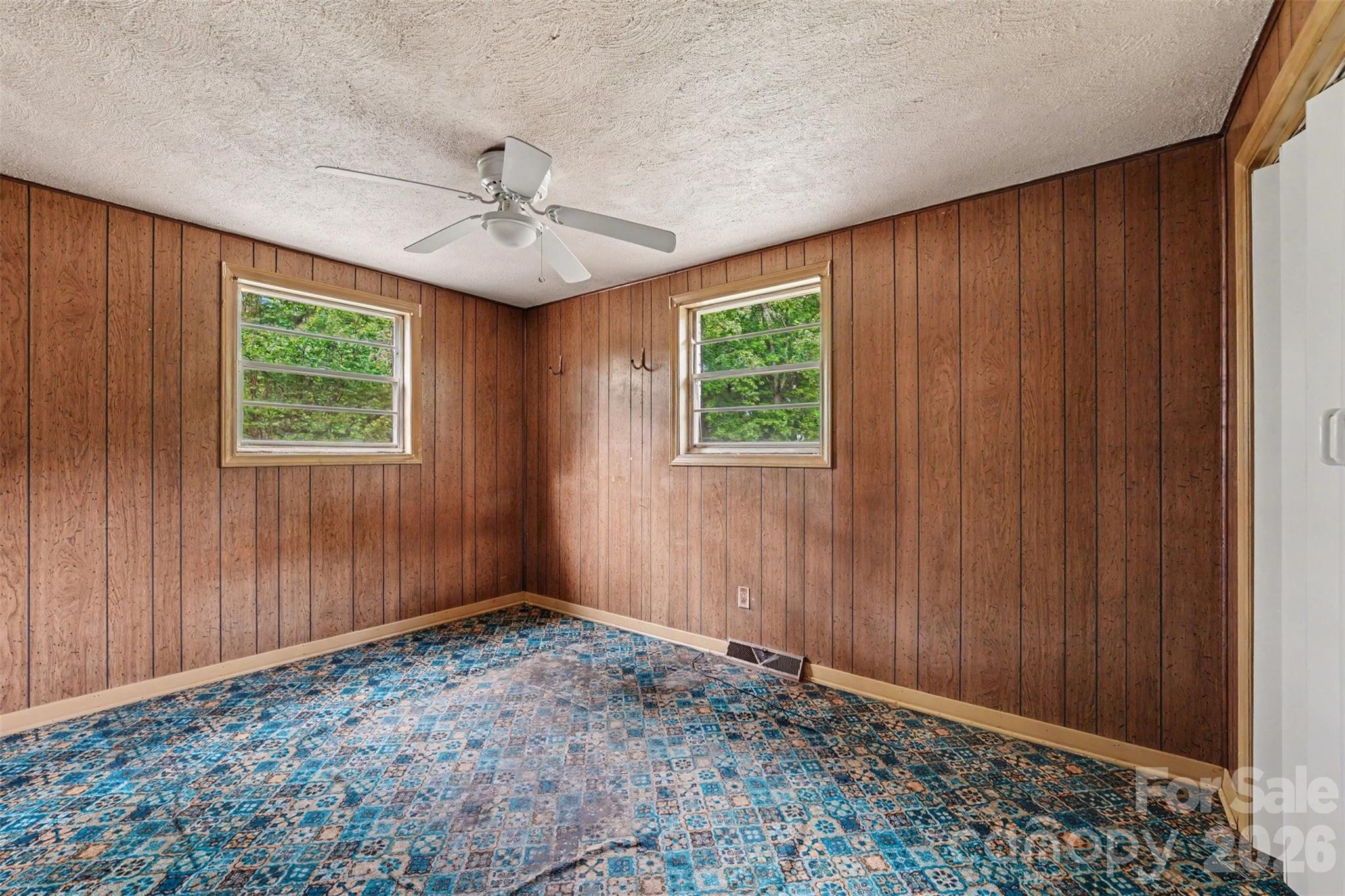 2871 Loviee Road Lincolnton, NC 28092 - Photo 8 of 14 an empty room with windows and ceiling fan
