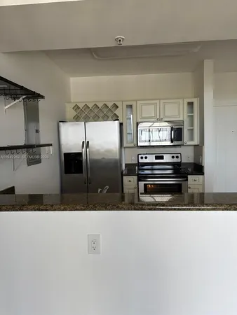 a kitchen with stainless steel appliances a refrigerator and a stove