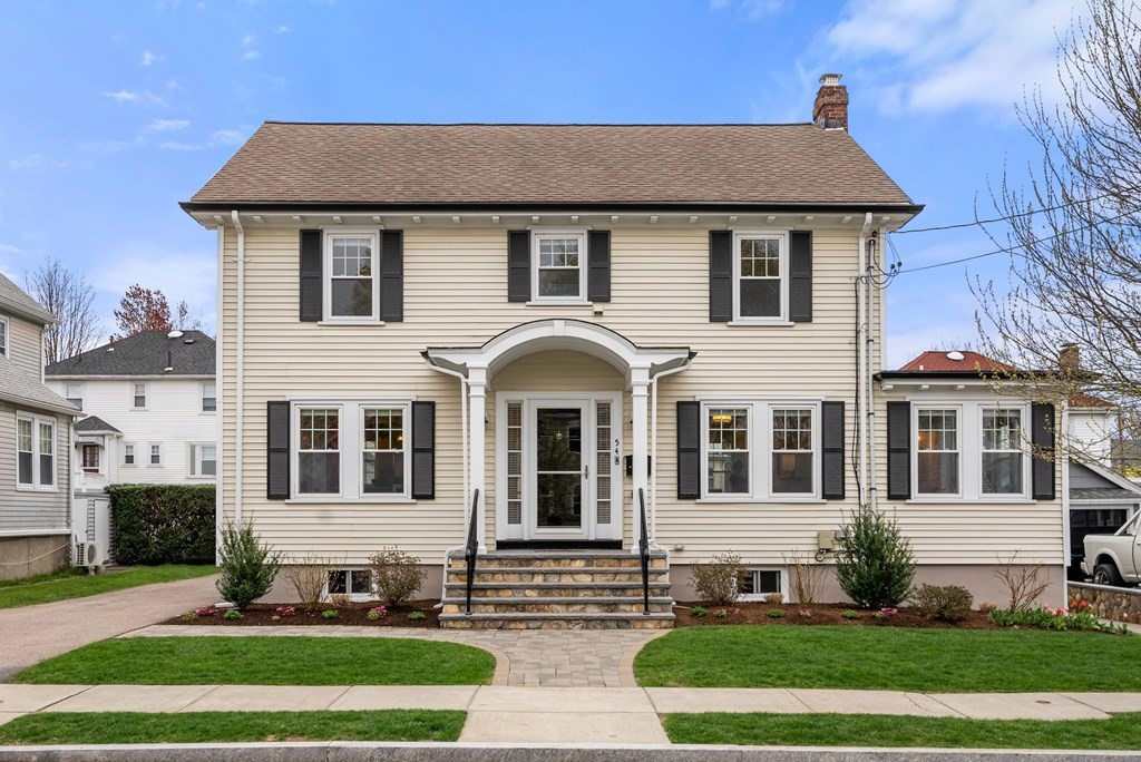 a front view of a house with a yard