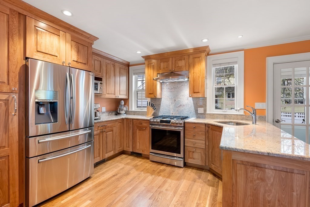54 Merrill Road Watertown, MA 02472 - Photo 14 of 36 a kitchen with granite countertop stainless steel appliances and wooden cabinets