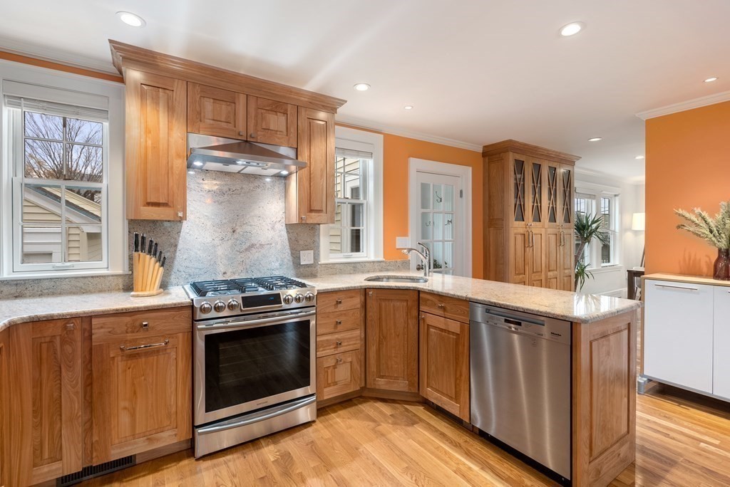 54 Merrill Road Watertown, MA 02472 - Photo 16 of 36 a kitchen with a stove top oven sink and cabinets