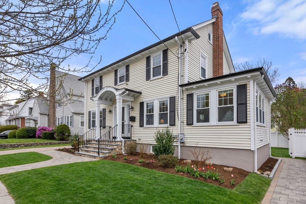 54 Merrill Road Watertown, MA 02472 - Photo 2 of 36 a front view of a house with a yard and porch