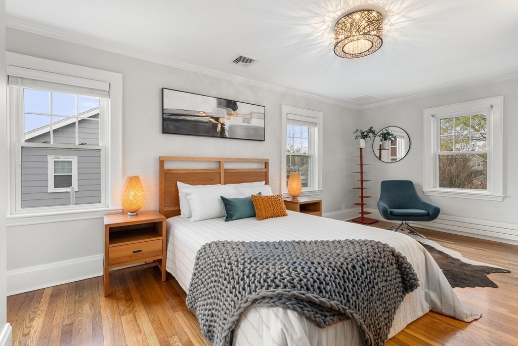 54 Merrill Road Watertown, MA 02472 - Photo 21 of 36 a bedroom with a bed and wooden floor