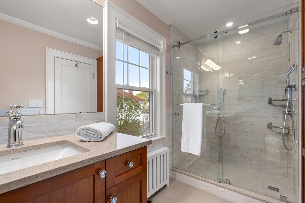 54 Merrill Road Watertown, MA 02472 - Photo 24 of 36 a bathroom with a granite countertop sink mirror and shower