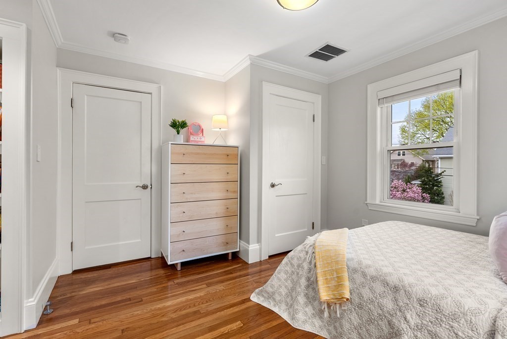 54 Merrill Road Watertown, MA 02472 - Photo 30 of 36 a bedroom with a bed and a window