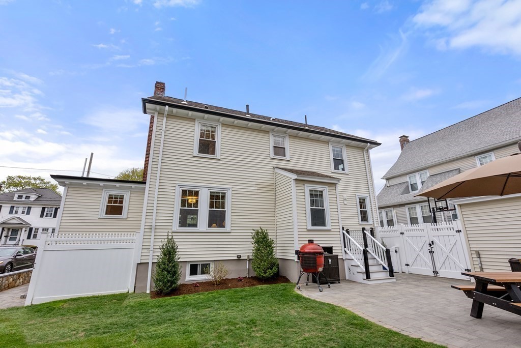 54 Merrill Road Watertown, MA 02472 - Photo 34 of 36 a backyard of a house with table and chairs
