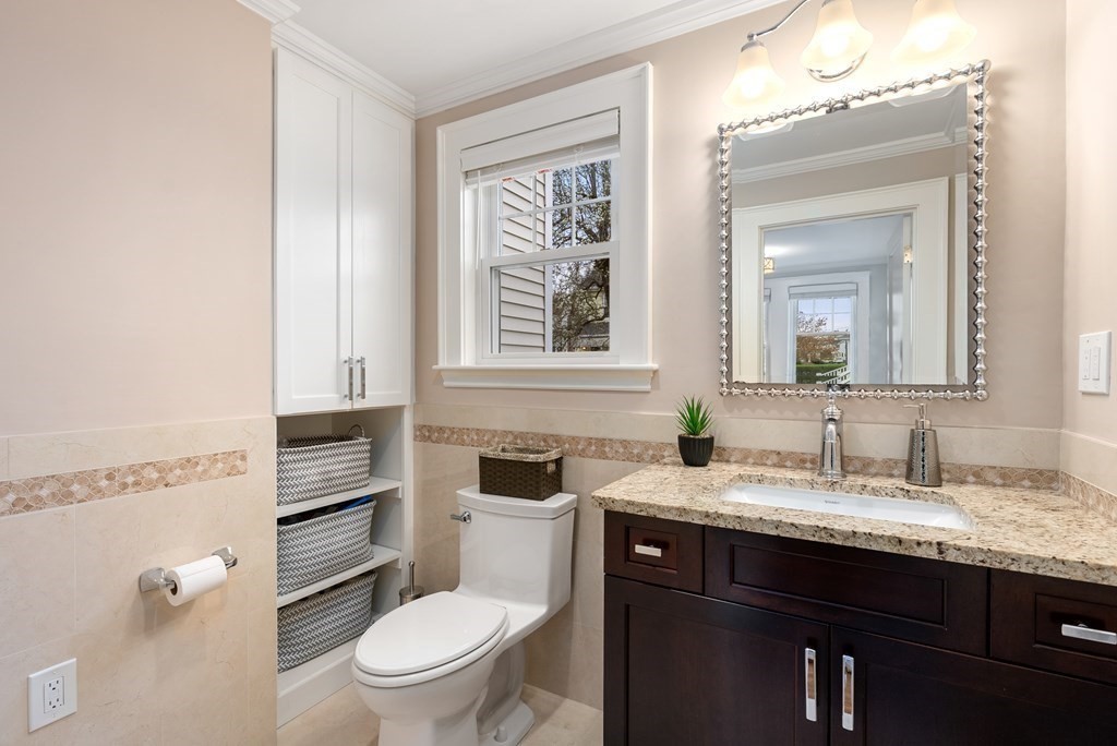 54 Merrill Road Watertown, MA 02472 - Photo 6 of 36 a bathroom with a granite countertop toilet sink and mirror