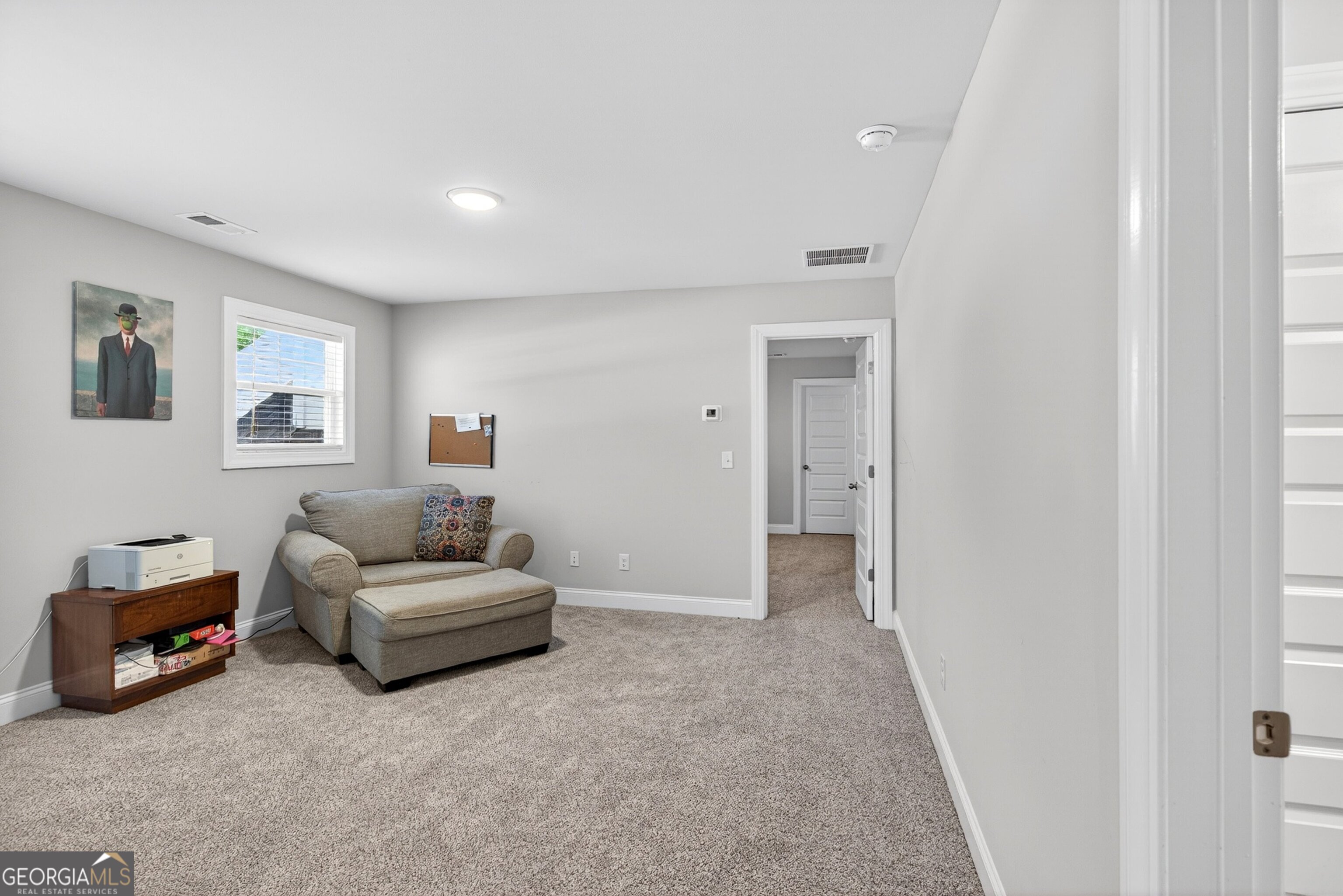1764 Luther Bailey Road Senoia, GA 30276 - Photo 36 of 63 a spacious bedroom with a bed and a couch