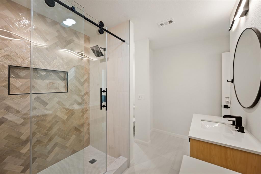 5009 Milam Street Dallas, TX 75206 - Photo 24 of 35 Bathroom with vanity and a stall shower