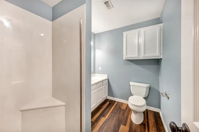 a white toilet sitting next to a bathroom sink