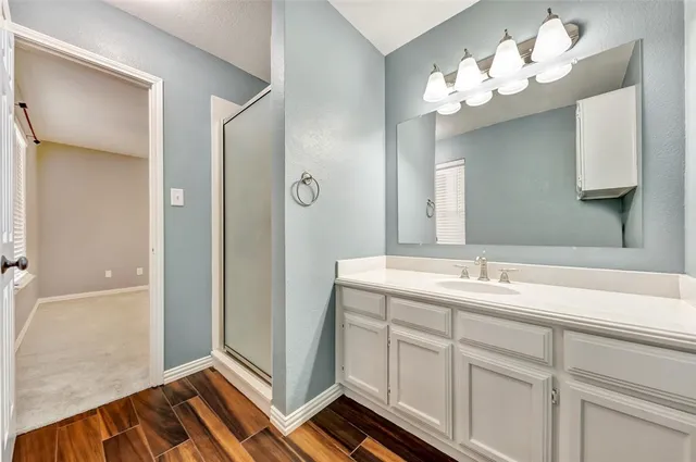 a bathroom with a double vanity sink and mirror