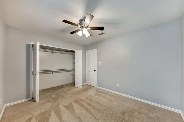 a view of a big room with wooden floor and closet in a room