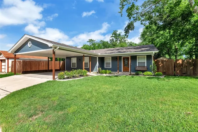 a front view of a house with a garden and porch
