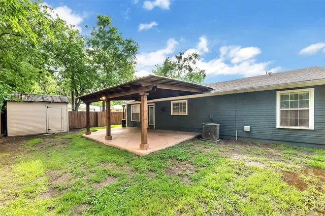 a backyard of a house with table and chairs