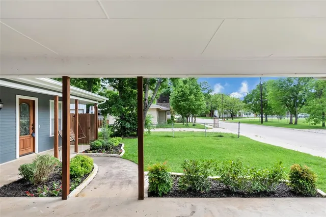a view of a house with backyard sitting area and garden