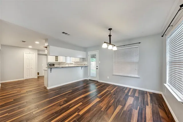 a view of kitchen with granite countertop cabinets and wooden floor