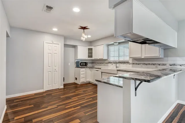 a kitchen with stainless steel appliances granite countertop a stove and a refrigerator