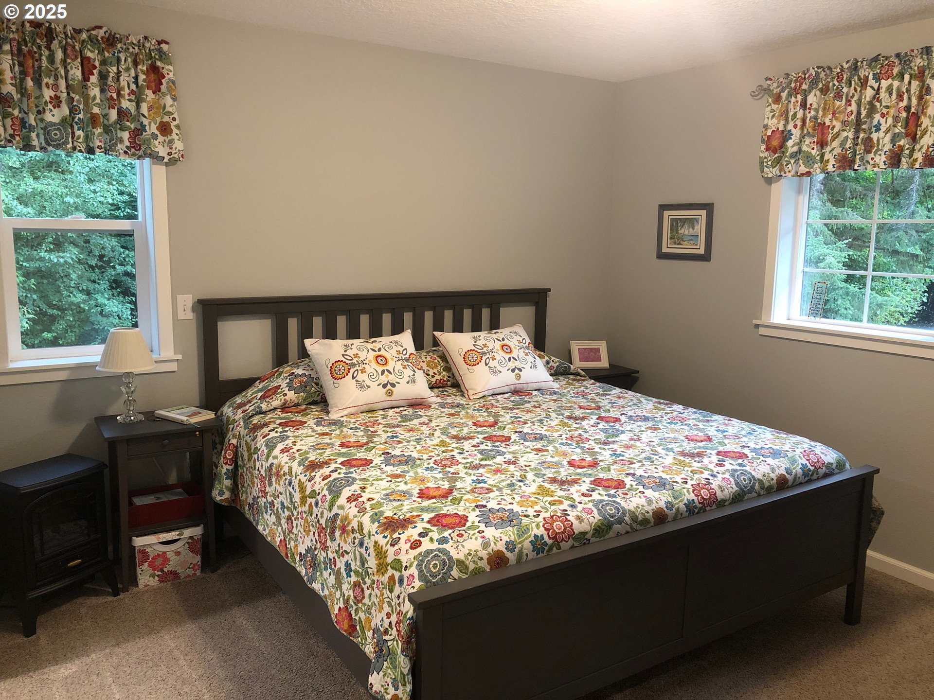 62941 Northwest Cochran Road Timber, OR 97144 - Photo 12 of 44 a bed sitting in a bedroom next to a window