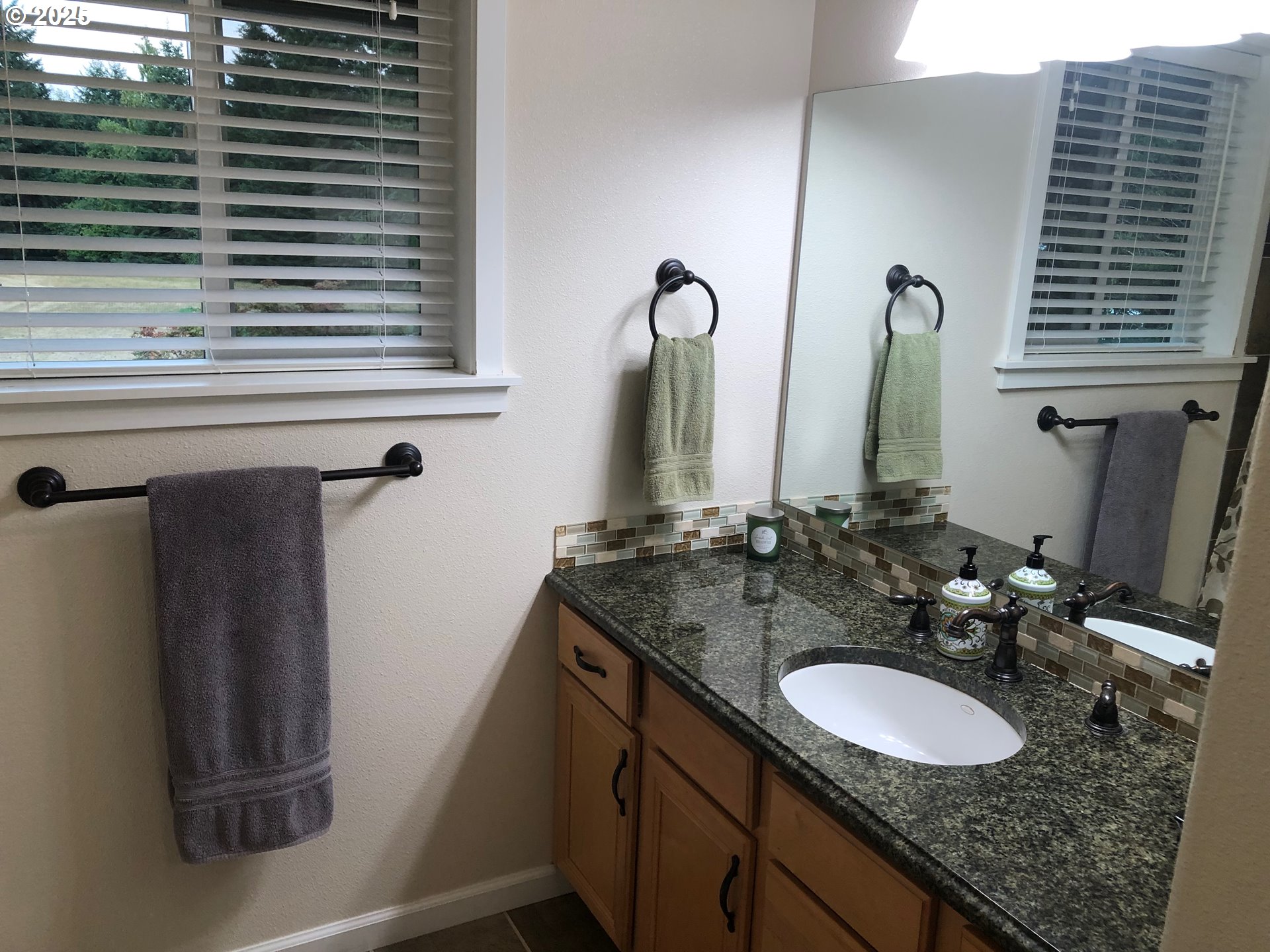 62941 Northwest Cochran Road Timber, OR 97144 - Photo 15 of 44 a bathroom with a granite countertop sink and a mirror