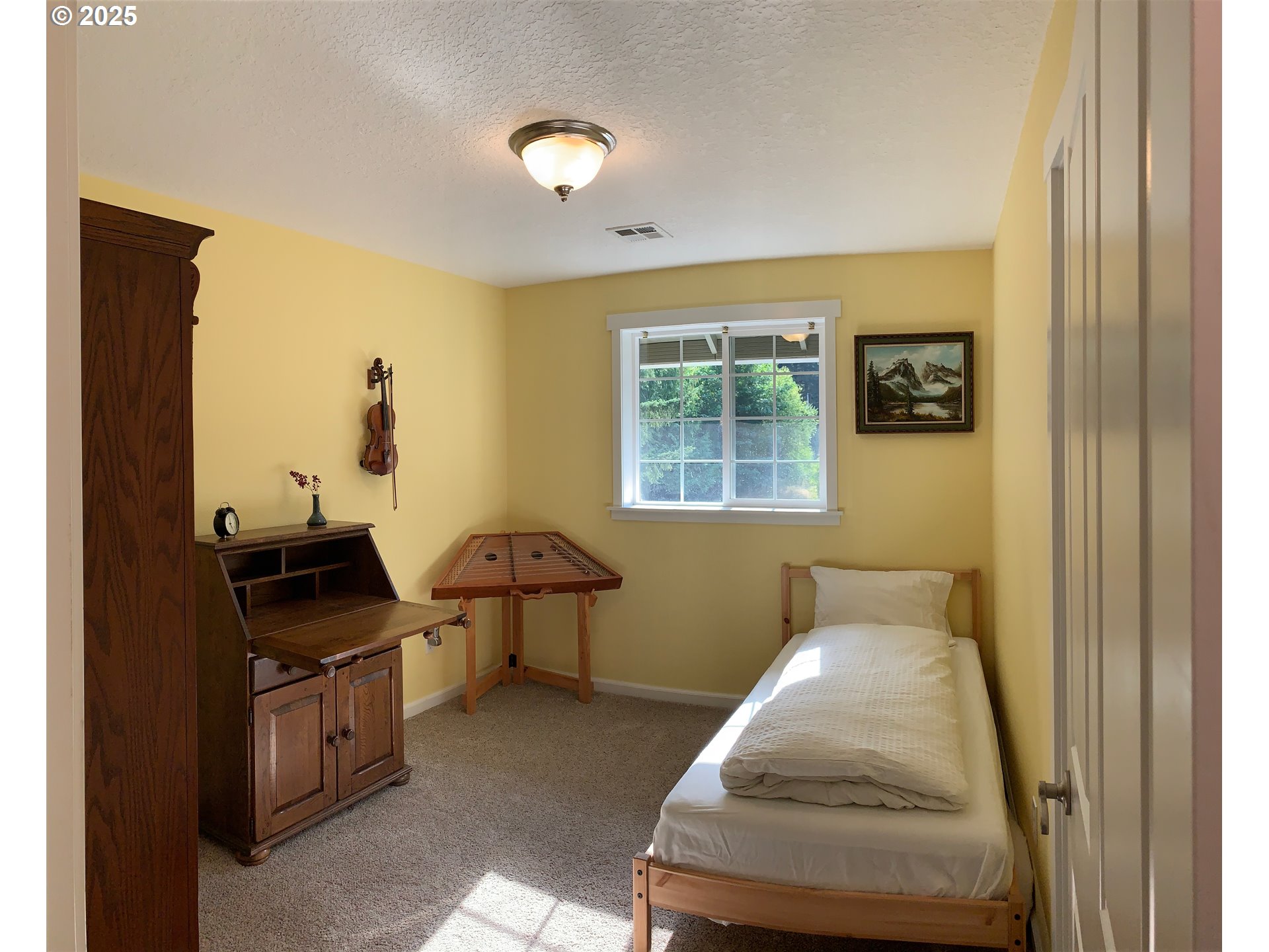 62941 Northwest Cochran Road Timber, OR 97144 - Photo 19 of 44 a bedroom with bed and window