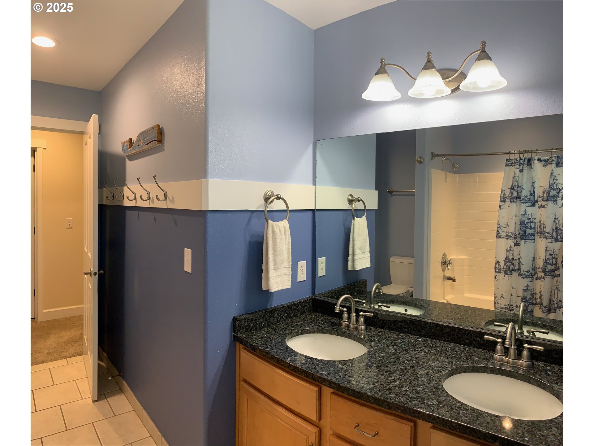 62941 Northwest Cochran Road Timber, OR 97144 - Photo 20 of 44 a bathroom with a double vanity sink and a mirror