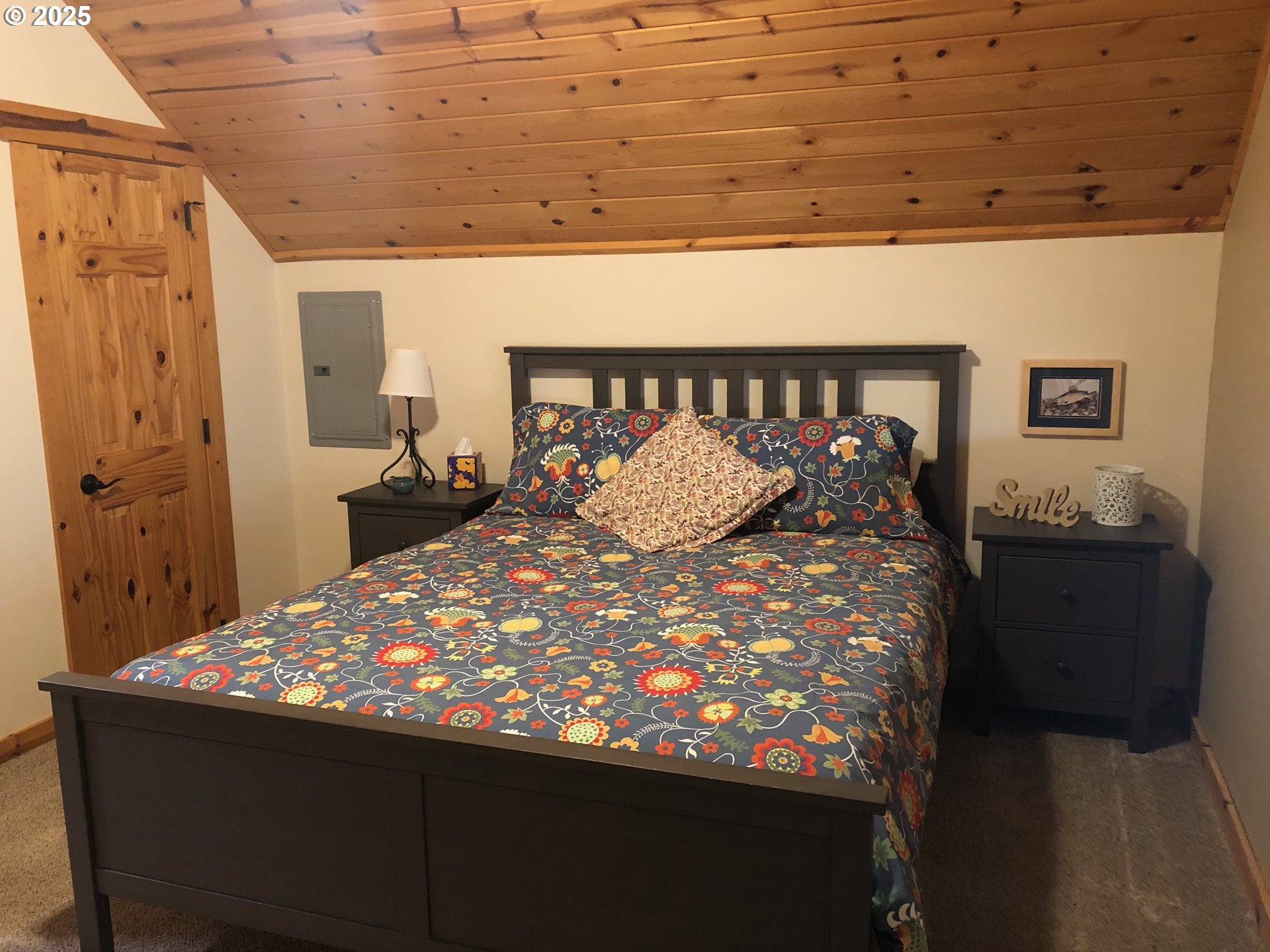 62941 Northwest Cochran Road Timber, OR 97144 - Photo 25 of 44 a bed sitting in a bedroom next to a bathroom