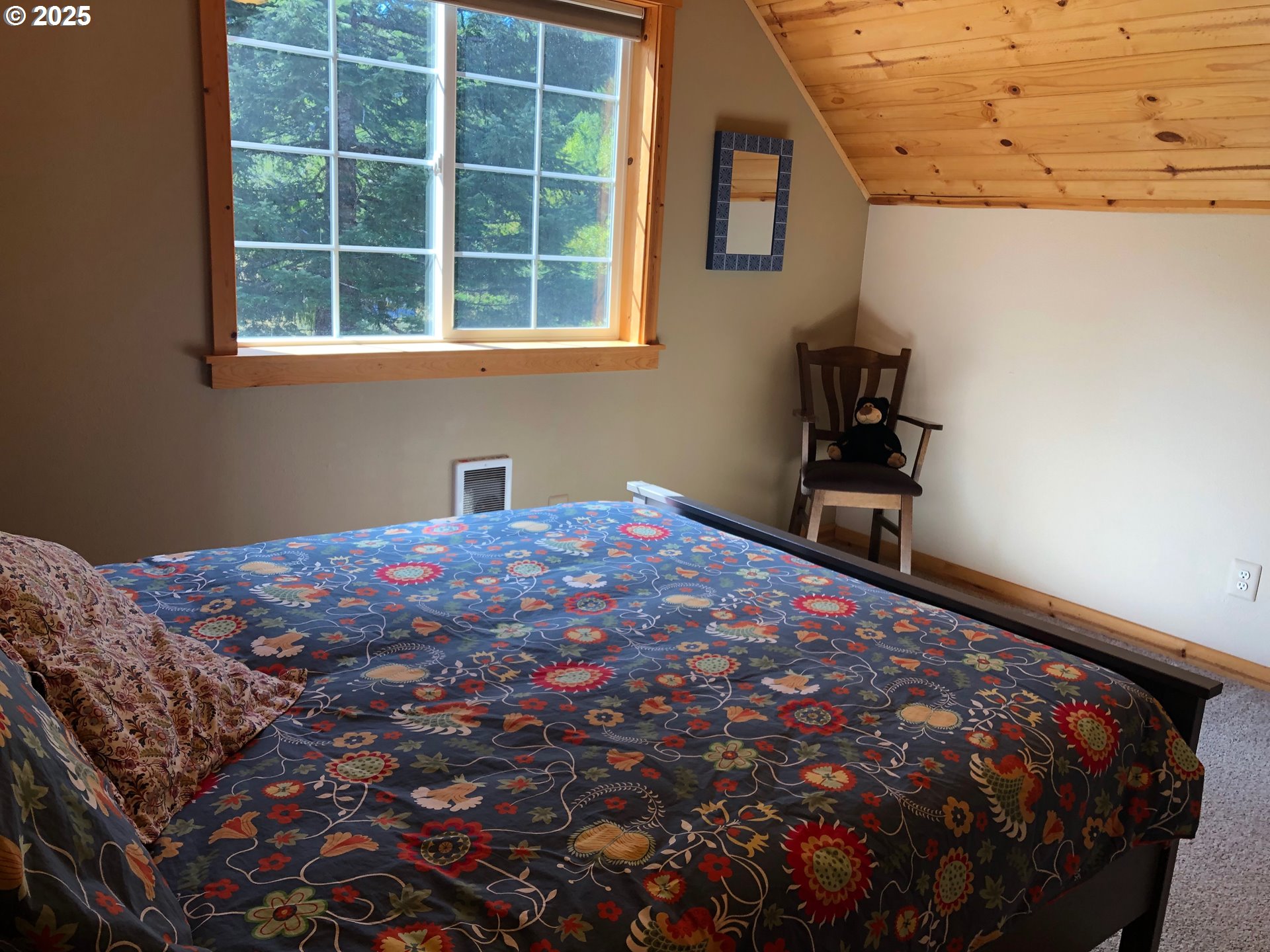 62941 Northwest Cochran Road Timber, OR 97144 - Photo 26 of 44 a bedroom with a bed and a window