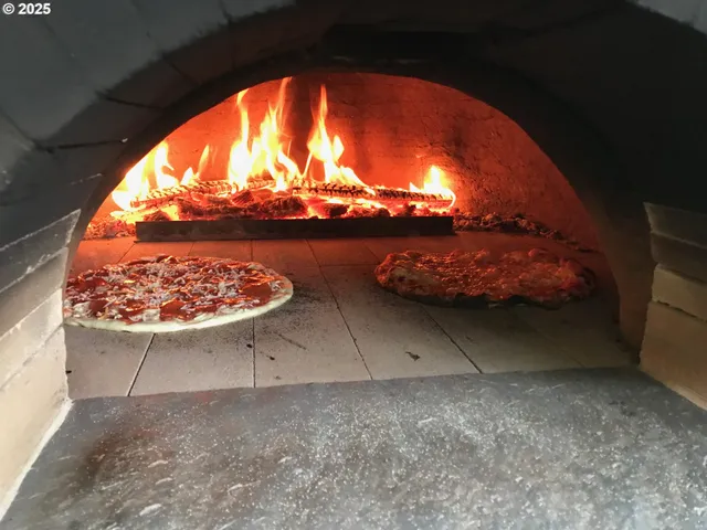 a view of a patio with table and chairs potted plants with large tree