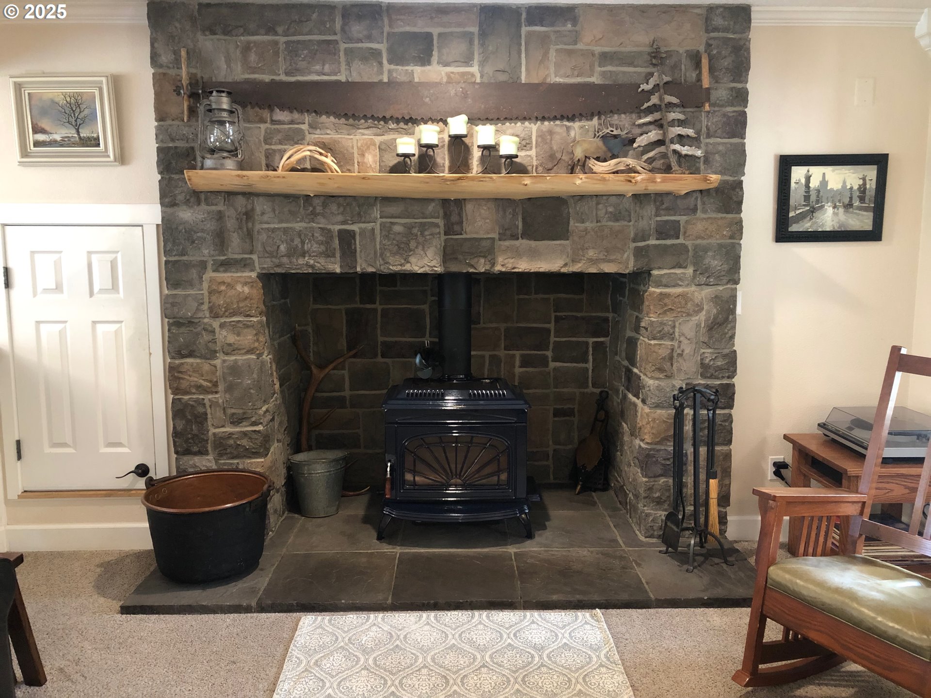 62941 Northwest Cochran Road Timber, OR 97144 - Photo 5 of 44 a kitchen with a stove and a fireplace