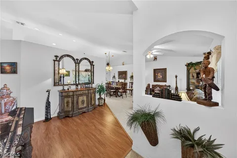 a very nice looking room with kitchen area and a potted plant