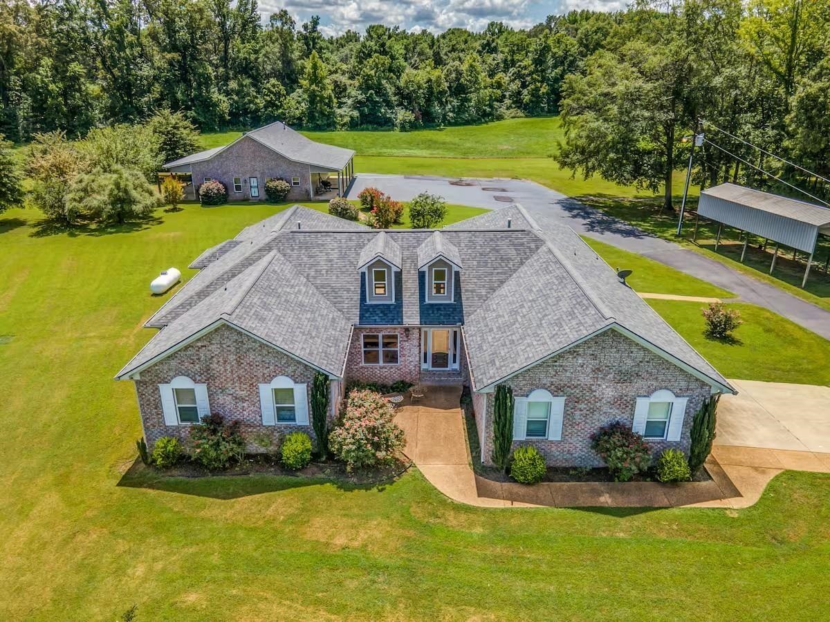 a aerial view of a house with swimming pool and a yard