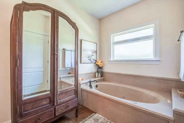 a spacious bathroom with a bathtub and a shower