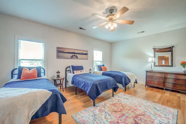 a bedroom with furniture and a large window