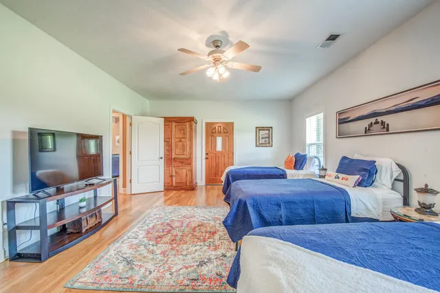 a bedroom with two beds and a flat screen tv