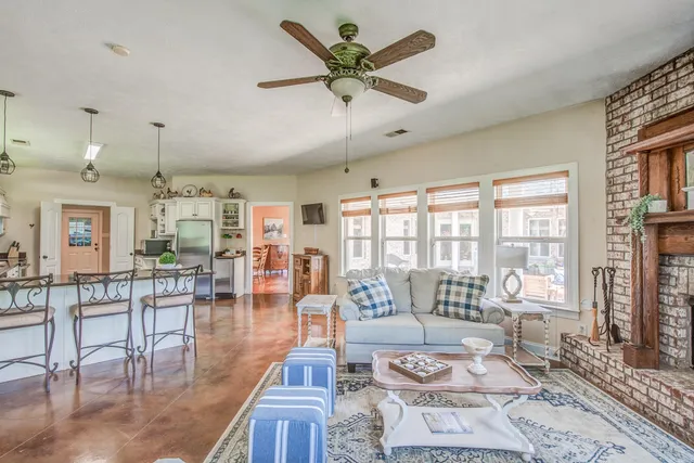 a living room with lots of furniture and a large window