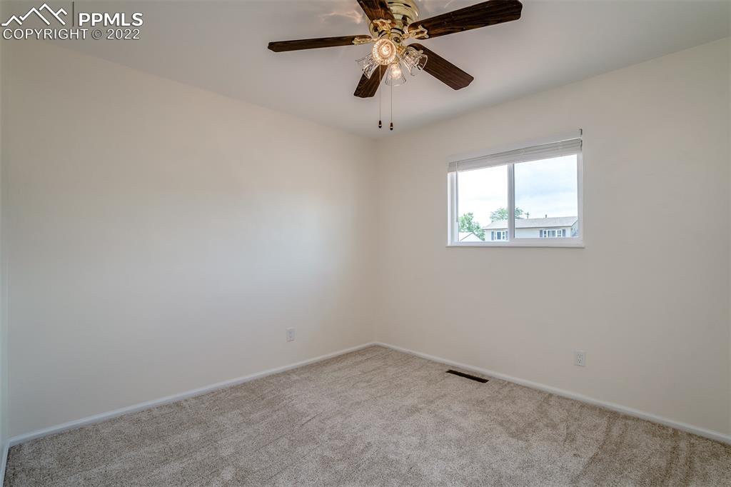 2515 Monterey Road Colorado Springs, CO 80910 - Photo 18 of 32 an empty room with a window and a fan