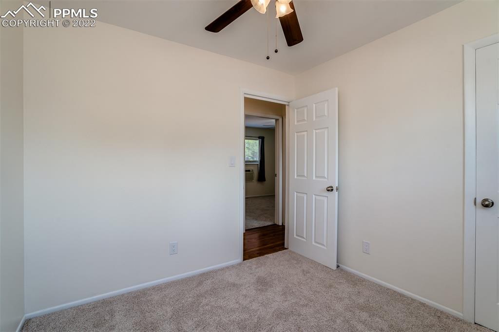 2515 Monterey Road Colorado Springs, CO 80910 - Photo 19 of 32 an empty room with ceiling fan and window
