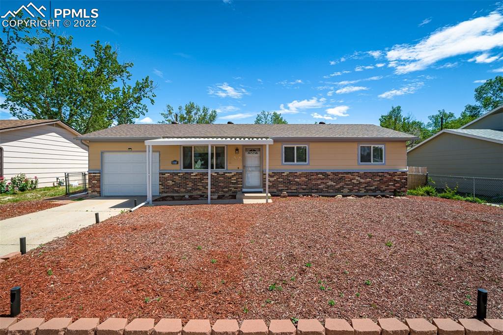 2515 Monterey Road Colorado Springs, CO 80910 - Photo 2 of 32 a front view of a house with yard patio and dinning table